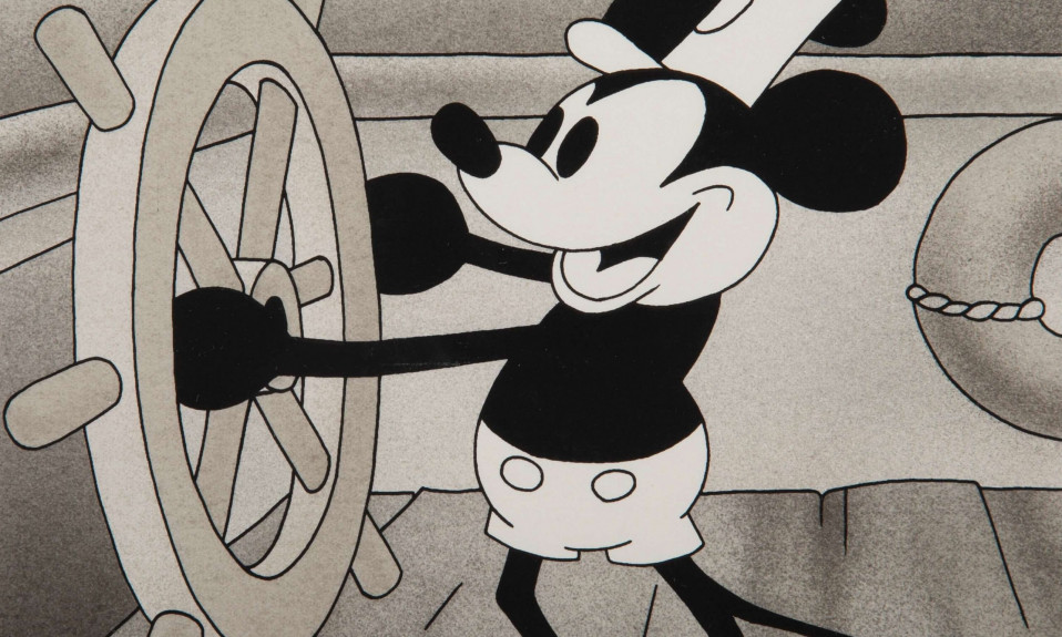 A black-and-white image of a cartoon mouse steering a boat. This image is from a frame of the 1928 animated short "Steamboat Willie", starring the character Mickey Mouse.